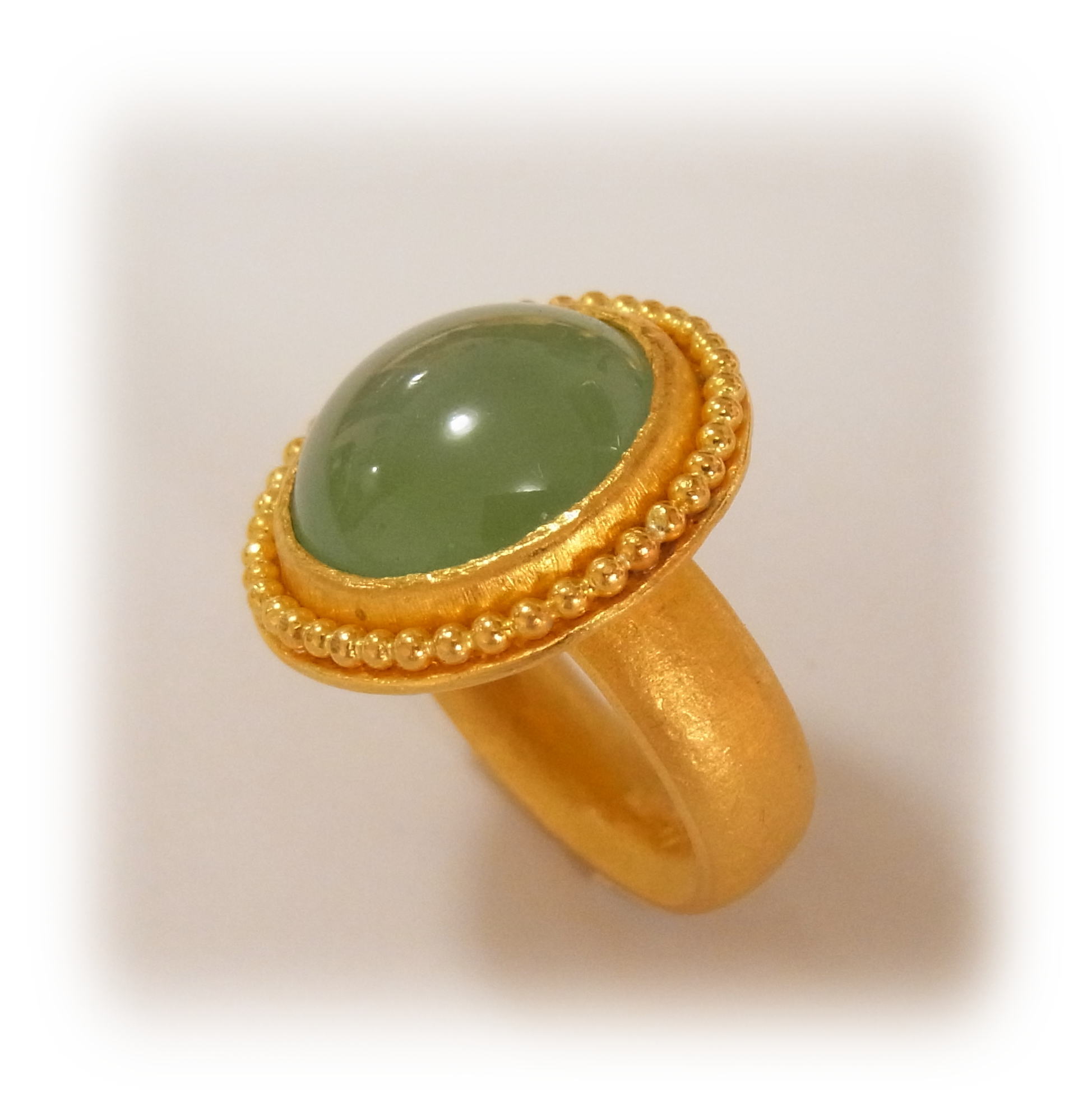 Round-cabochon green Jadeite ring with gold granulation (seen from the side)