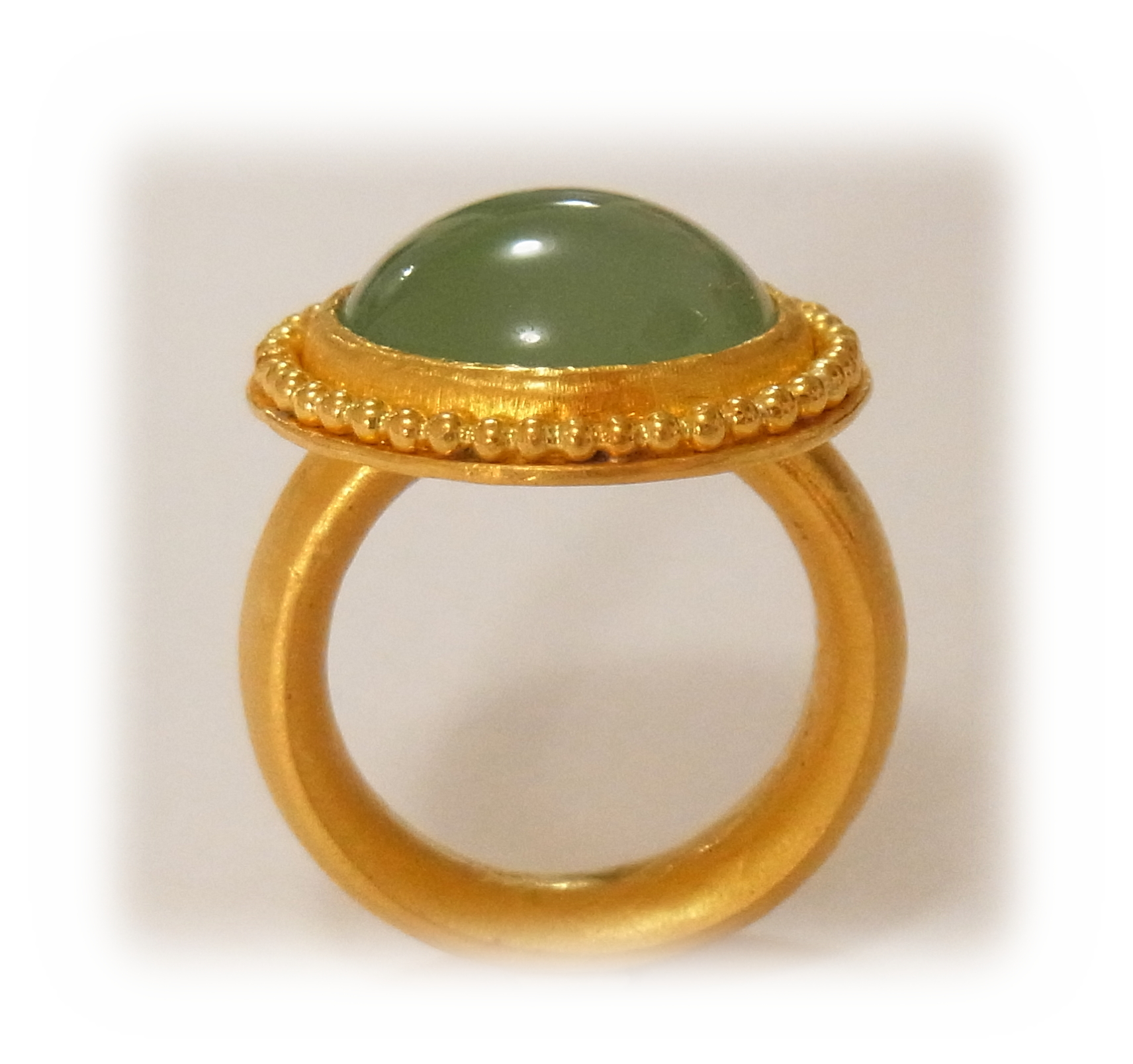 Round-cabochon green Jadeite ring with gold granulation (seen from the front)